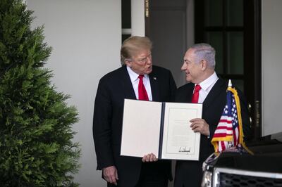 Israeli Prime Minister Benjamin Netanyahu holds up a proclamation signed by US President Donald Trump recognising Israeli sovereignty over the Golan Heights, at the White House on March 25, 2019. Bloomberg