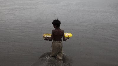 A boy walks in the River Ravi to release oil lamps and candles during the Shab-e-Barat festival in Lahore, Pakistan. Mohsin Raza / Reuters
