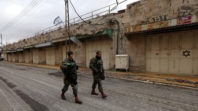 Israeli soldiers walk in the West Bank town of Hebron. EPA