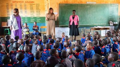 US First Lady Melania Trump speaks to the children as head teacher Maureen Masi listens on during her visit to the Chipala Primary School in Lilongwe. Saul Loeb / AFP