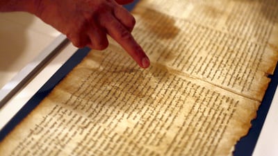 A part of the Isaiah Scroll, one of the Dead Sea Scrolls, is presented inside the vault at the Israel Museum. Getty Images