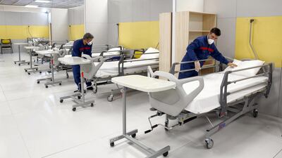 Iranian workers set up a makeshift hospital inside the Iran Mall, northwest of Tehran, on March 21, 2020 amid the coronavirus outbreak. - Iran said that 123 more people had died from coronavirus, raising the official death toll to 1,556 in the Islamic republic, one of the world's worst affected countries. AFP