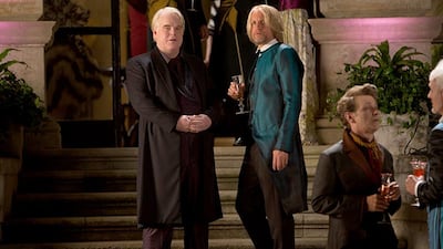 This image released by Lionsgate shows Philip Seymour Hoffman as Plutarch Heavensbee, left, and Woody Harrelson as Haymitch Abernathy in a scene from "The Hunger Games: Catching Fire." (AP Photo/Lionsgate, Murray Close)