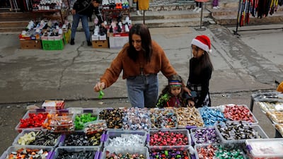 An Iraqi Christian family buys candies ahead of Christmas at a store in Al Hamdaniya. Reuters