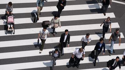 Pedestrians walk cross an intersection in Tokyo. Japan’s service producer price index figures are scheduled to be released on May 26. Akio Kon / Bloomberg