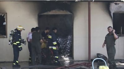 Fire fighters and members of the civil defence finish putting out a fire in a small room located beside a villa in the area of 15th and 32nd streets in Abu Dhabi, United Arab Emirates.