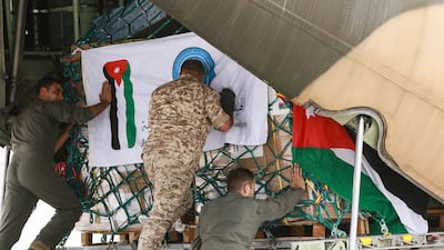 Workers at Marka military airport in Amman, Jordan, load a military plane with humanitarian aid for Libya. AFP
