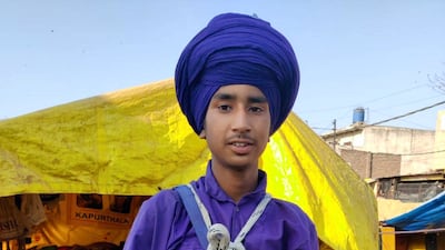 Sartaj Singh, 15, displays the traditional iron bowl that Nihangs must eat their meals from. Taniya Dutta for The National