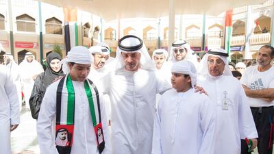 Sheikh Hazza bin Zayed, Vice Chairman of the Abu Dhabi Executive Council, centre, speaks with Zayed Al Thani School students on Flag Day. Mohamed Al Suwaidi / Crown Prince Court — Abu Dhabi