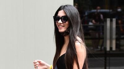 A guest arrives at the Dolce & Gabbana show during Milan Men's Fashion Week on June 19, 2021 in Milan, Italy. AFP