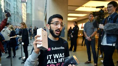 Mazen Kourouche shows off the new Apple products at the Apple Store in Sydney. Joel Carrett / EPA