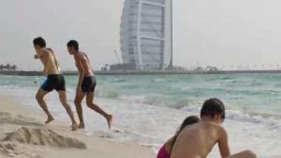 Visitors play on Jumeriah beach.