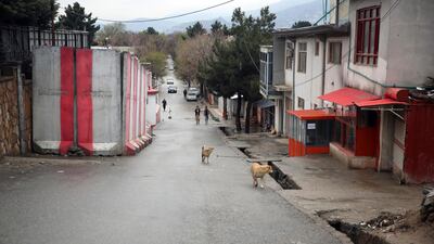 People walk on a mostly empty street during a lockdown aimed at curbing the spread of the coronavirus in Kabul. AP