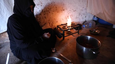 Um Samer, a displaced woman from eastern Ghouta, prepares an iftar meal at their home in Maarrat Misrin some seven kilometres north of Idlib. Omar Haj Kadour/ AFP