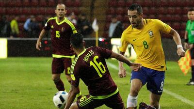 Brazil midfielder Renato Augusto is challenged by Venezuela’s Roberto Rosales. Marco Bello / Reuters
