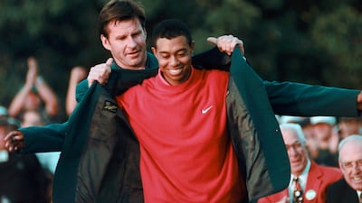 Tiger Woods receives his Green Jacket from Nick Faldo, left, after winning the 1997 US Masters. AP Photo