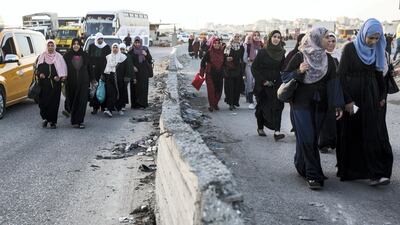 Palestinian women of all ages crossing the Qalandia checkpoint to pray in Jerusalem. The Friday mornings during Ramadan is the most crowded foot traffic time at Qalandia, as tens of thousands of Palestinians from all around the West Bank cross through to pray in Jerusalem. Photo by Heidi Levine for The National