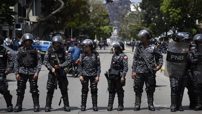 Bolivarian National Police officers stand in formation during an anti-government protest in Caracas, Venezuela. Bloomberg