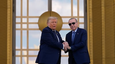 A warm greeting shared by Mr Trump and Mr Erdogan. EPA