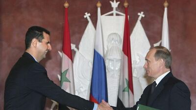Syrian President Bashar Assad, left, and Russian President Vladimir Putin shake hands during a signing ceremony in the Kremlin, Moscow. Sergei Chirikov / AP