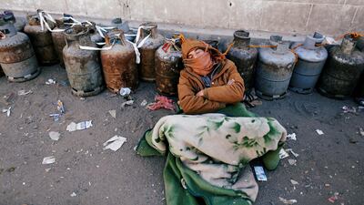 A man sleeps next to a queue of cooking gas cylinders outside a gas filling station amid a scarcity in cooking gas supplies in Sanaa, Yemen. Khaled Abdullah / Reuters