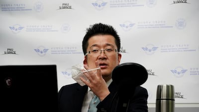 Park Hyun, a professor at Pusan National University Park Hyun, who used to be a coronavirus patient, takes off his mask as he gives an online lecture at Pusan National University in Busan. Reuters