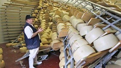 Parmesan wheels are left in disarray in San Giovanni, Italy, following the earthquake. AP Photo