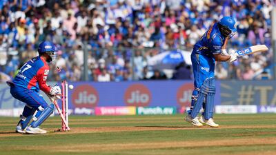 Mumbai Indians' Rohit Sharma is bowled out by Delhi Capitals' Axar Patel. AP