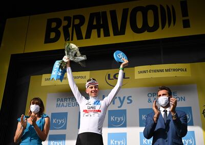 UAE Team Emirates team's Slovenian rider Tadej Pogacar celebrates on the podium with the Best Young Rider's white jersey. AFP.