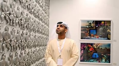 Art Dubai intern Hassan Al Darwish checks out Riyas Komu’s aluminum sculpture “Blood Brothers” during the “Jumeirah Patrons’ Preview” at the Madinat Jumeirah in Dubai.