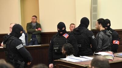 In this file photo taken on February 5, 2018 prime suspect in the November 2015 Paris attacks Salah Abdeslam (L) sits beside his alleged accomplice Sofiane Ayari (R) as they are surrounded by Belgian special police officers in the courtroom at the "Palais de Justice" courthouse in Brussels for the opening of his trial. Emmanuel Dunand/ AFP Photo