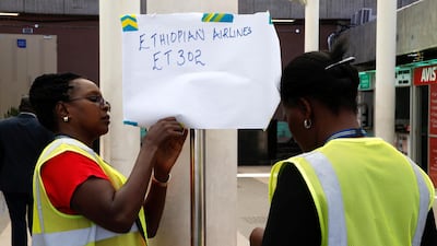 Kenya Airports Authority workers hang an information notice at the Jomo Kenyatta International Airport in Nairobi, Kenya. Reuters