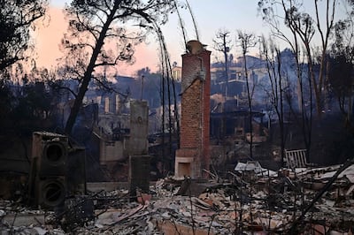 A chimney stands amid the rubble after the passage of the Palisades Fire in Pacific Palisades. AFP