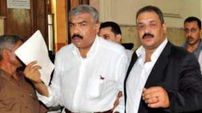 Hisham Talaat Mustafa (L) seen accompanied by his lawyer into the courtroom in Cairo last year