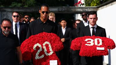 Liverpool's captain Virgil van Dijk and teammate Andrew Robertson carry wreaths as they arrive on in Portugal for the funeral ceremony of Diogo Jota and his brother Andre Silva, who died in a car crash last week. Reuters