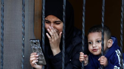 A relative of of Palestinian Yazan Abu Tabekh, who was killed during an Israeli raid, reacts as she looks through a window during his funeral in Jenin in the Israeli-occupied West Bank. Reuters