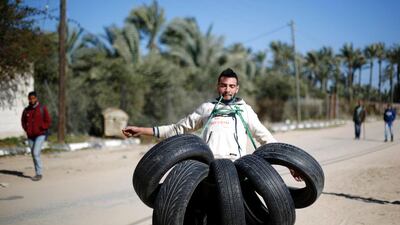 Mohammed Baraka, nicknamed ‘Gaza’s Samson’, lifts a bunch of tyres with his teeth in Deir Al Balah, central Gaza, on January 4, 2016. Mohammed Abed / AFP