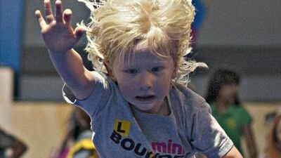 A toddler jumps from a trampoline and dives into an inflated landing mattress at Bounce. Jeff Topping for The National