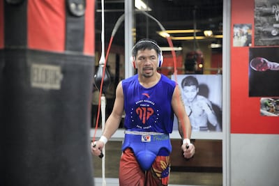 By the time the gloves are laced, Manny Pacquiao glistens with sweat and his midnight-black hair has dampened. Jake Verzosa for The National