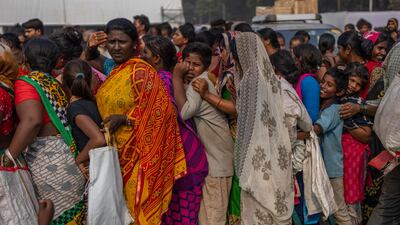 Indian women and children queue for free food distributed to mark the anniversary of Bhim Rao Ambedkar's death in Mumbai. Ambedkar was the chief architect of the Indian constitution, which outlawed discrimination based on caste. AP