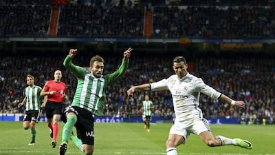 Real Madrid’s Cristiano Ronaldo, right, challenges Real Betis’ Alin Tosca. Francisco Seco / AP Photo