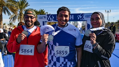 Participants pose with medals at the end of the race.