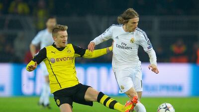 Marco Reus of Borussia Dortmund tackles Luka Modric of Real Madrid during their Uefa Champions League quarter-final second leg at Signal Iduna Park on April 8, 2014, in Dortmund, Germany. Dennis Grombkowski / Getty Images
