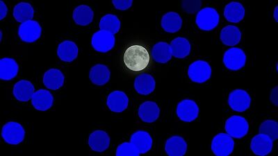 The moon shines behind the Lanterns at the Wonderland Mid- Autumn festival at Victoria Park in Hong Kong, China. Lam Yik Fei / Getty