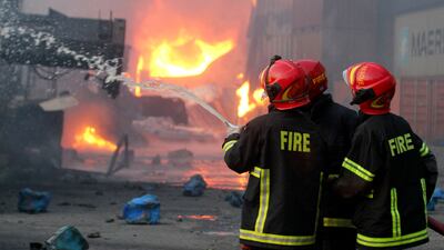 Firefighters try to extinguish a blaze that broke out at a container storage site in Sitakunda, about 40 kilometres from the port of Chittagong in Bangladesh. AFP