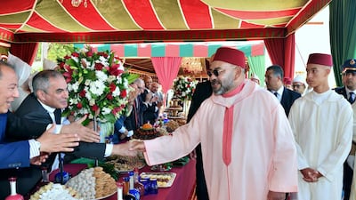 In this photo provided by the Moroccan Royal Palace, Morocco's King Mohammed VI, center, attends a ceremony at the Royal Palace in Tetouan, Morocco, on Tuesday, July 30, 2019, as part of the 'Day of the Throne' ceremonies, the 20th anniversary of the King's accession to the Throne. (Moroccan Royal Palace via AP)