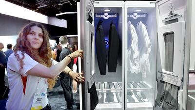 An LG spokesperson demostrates the LG Styler, a household clothing care machine. The upright machine removes wrinkles and sanitise clothing. David Becker / Getty Images / AFP