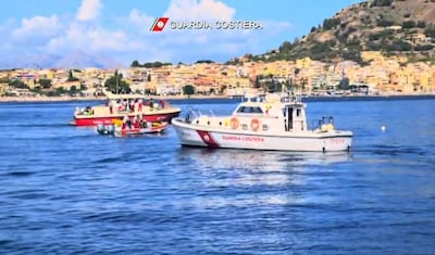 An Italian Coastguard boat and a fireboat search for the missing. AFP