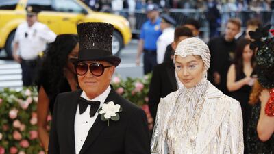 While Gigi Hadid looked ethereal in silvery white, it was designer Michael Kors in a flared tuxedo and top hat that stole the show. EPA