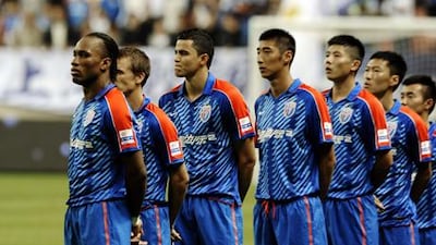Didier Drogba with his Shanghai Shenhua teammates ahead of their match with Liaoning Whowin